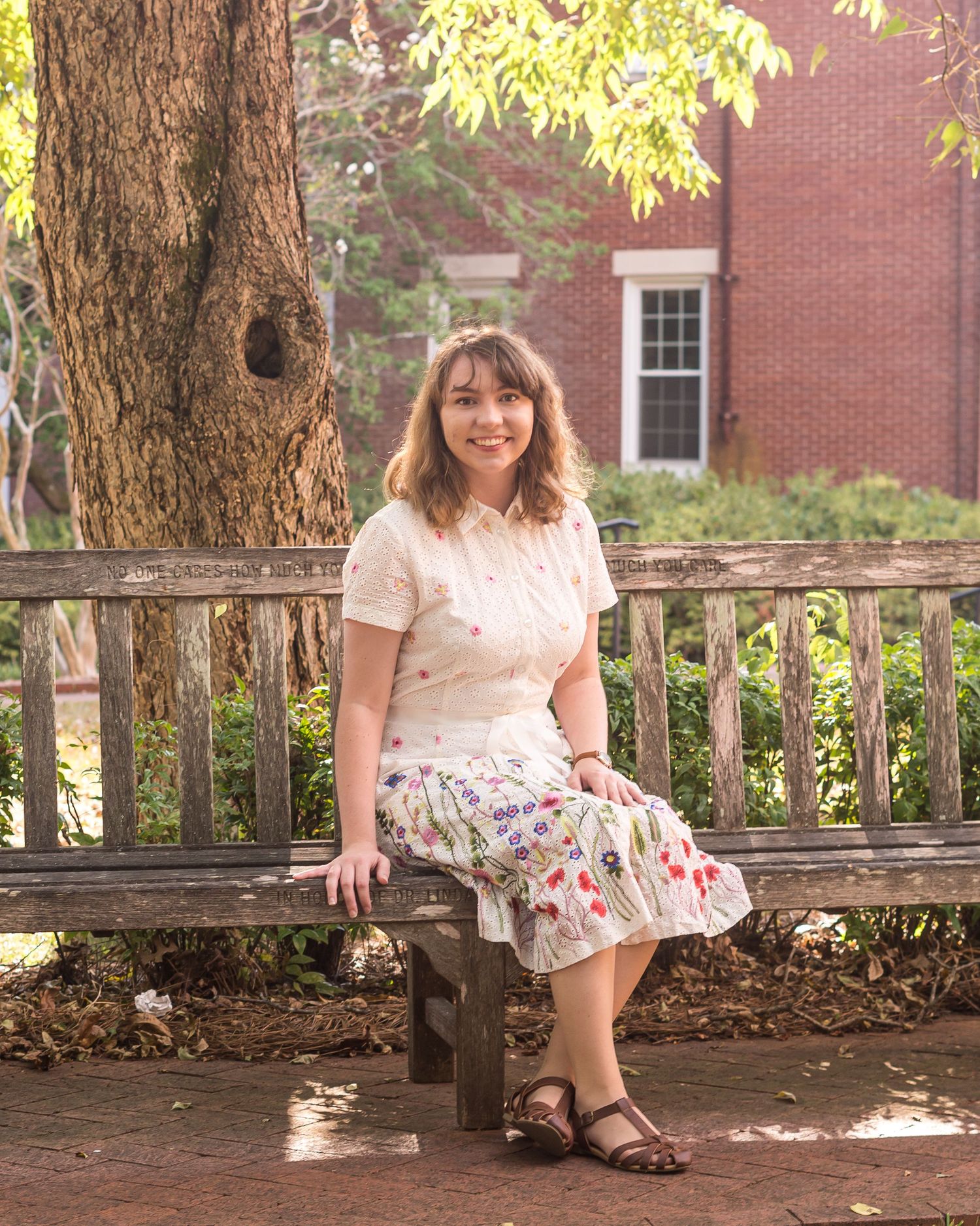 college graduate sitting on a bench