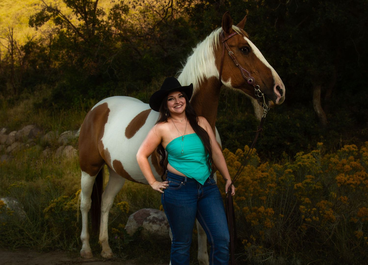 Woman with her horse posing for an Equestrian photoshoot. Taken at Yellowfork Canyon, Herriman, Utah.