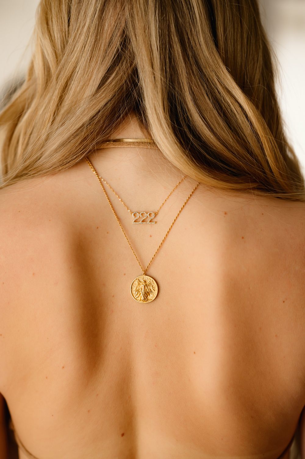 Brand photography portrait by Santa Barbara brand photographer of woman wearing necklace backwards for jewelry business