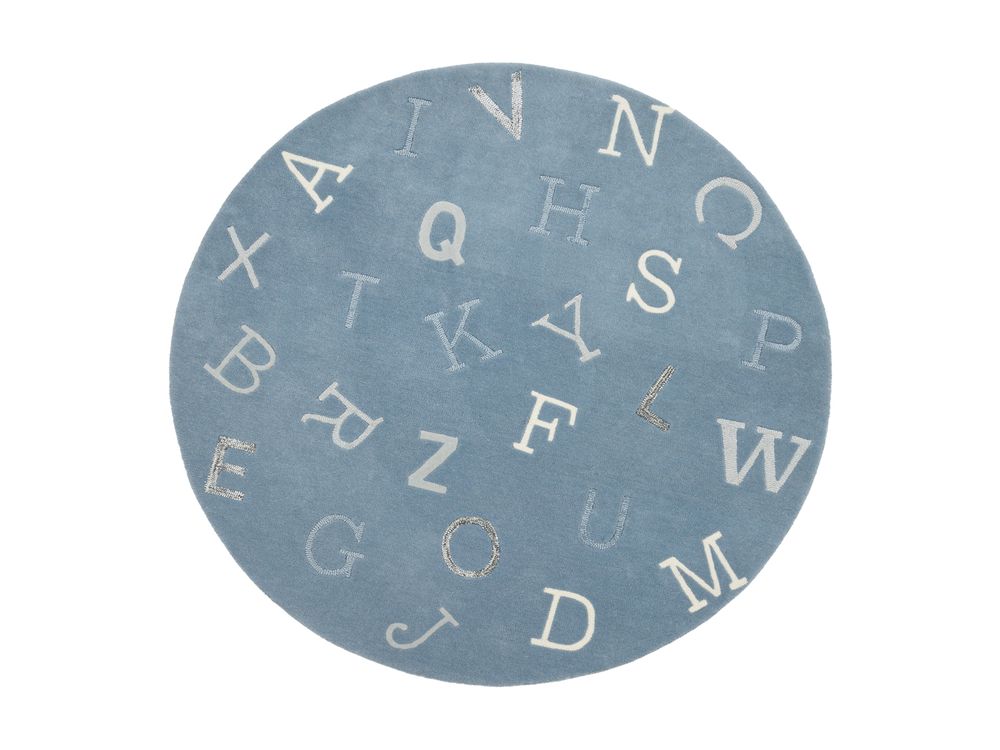 Round blue kids rug with scattered alphabet letters in white and grey on light background.