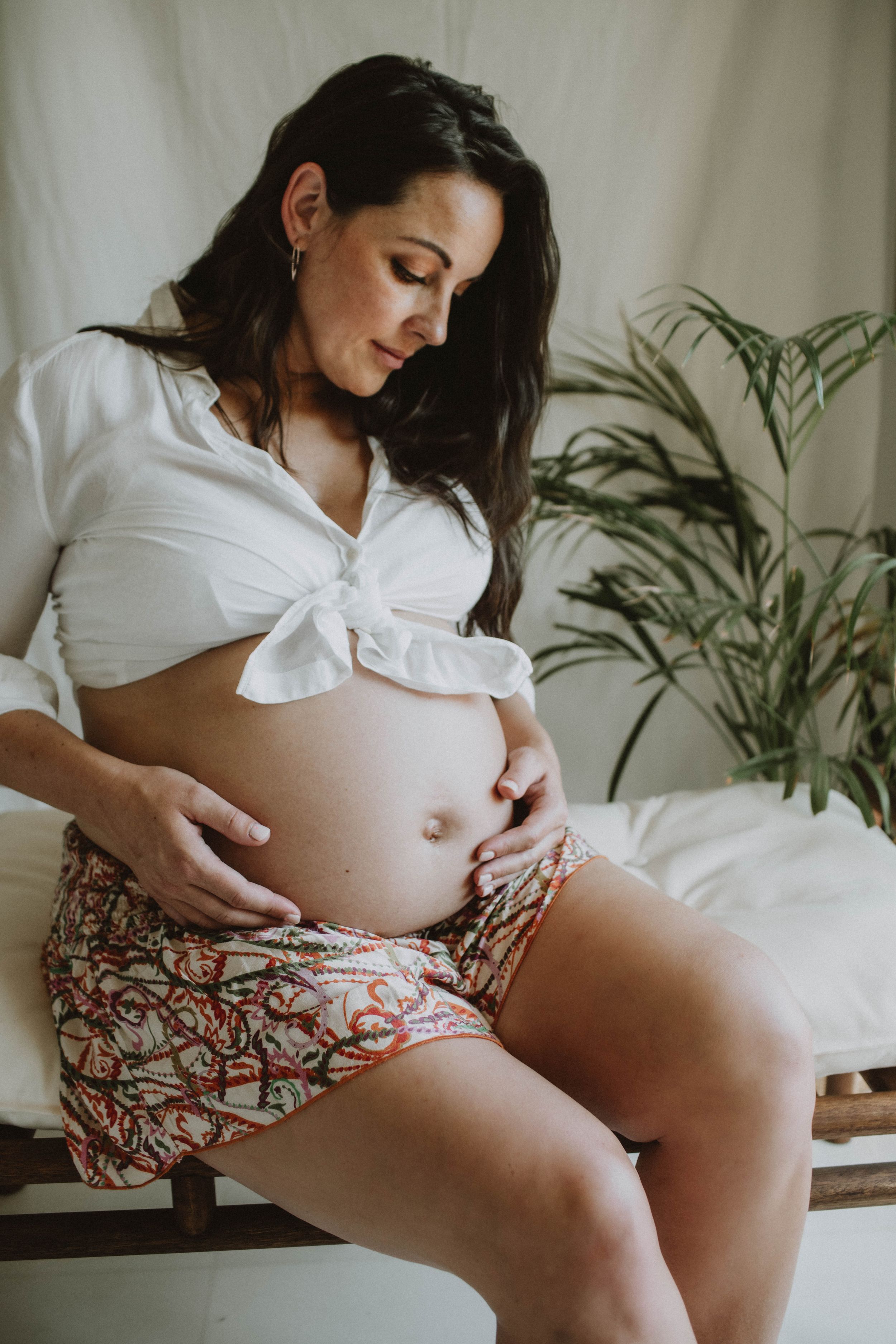 Indoor lifestyle maternity session in Sydney & Northern Beaches, with a small photography set and natural light, capturing tender and elegan