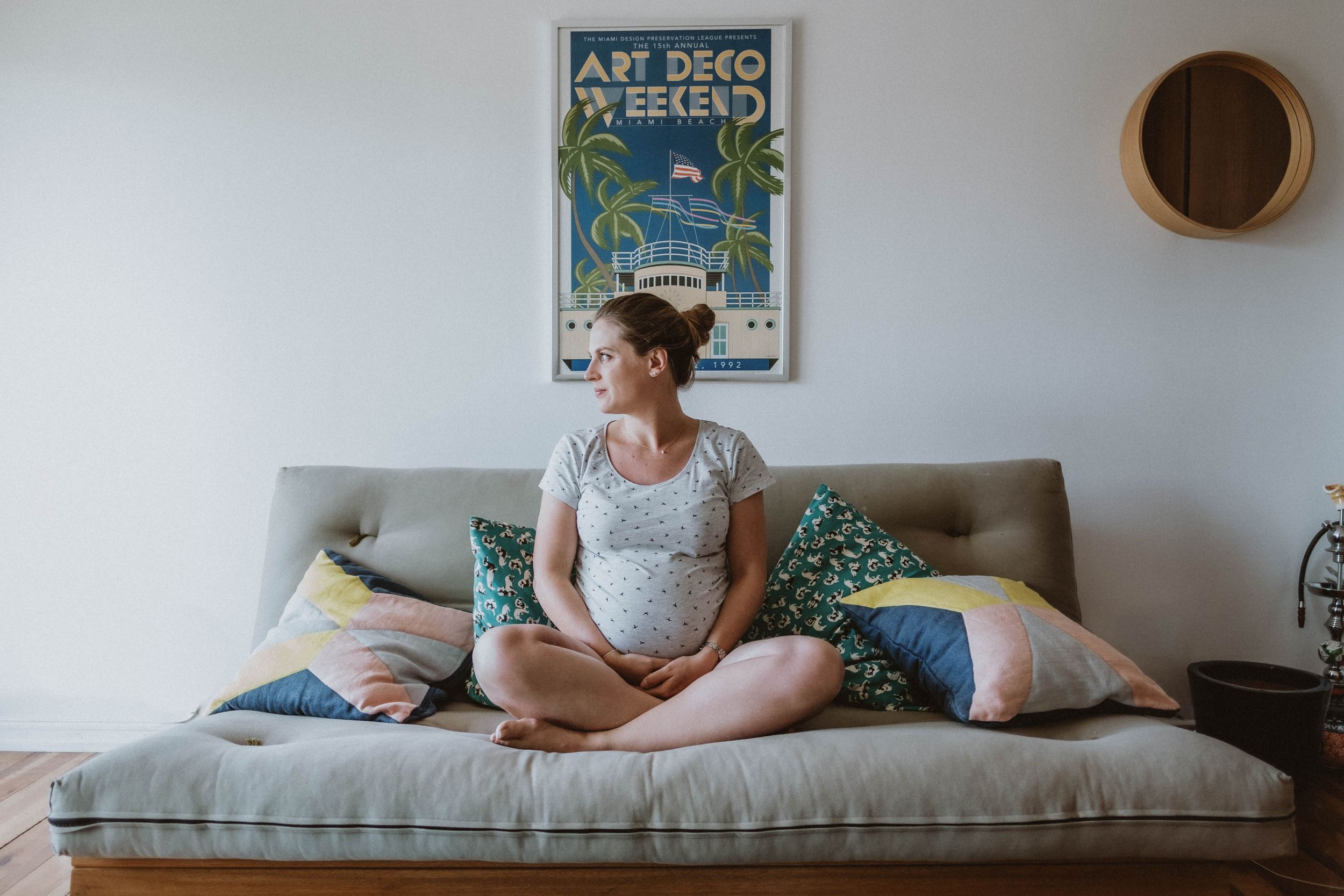 Solo indoor maternity session with a mother, emphasizing natural light and intimate pregnancy moments.