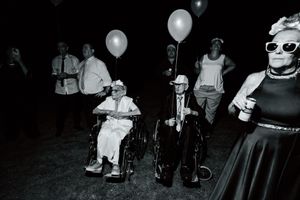 Nighttime celebration with glowing balloons and party lights creating a festive atmosphere.