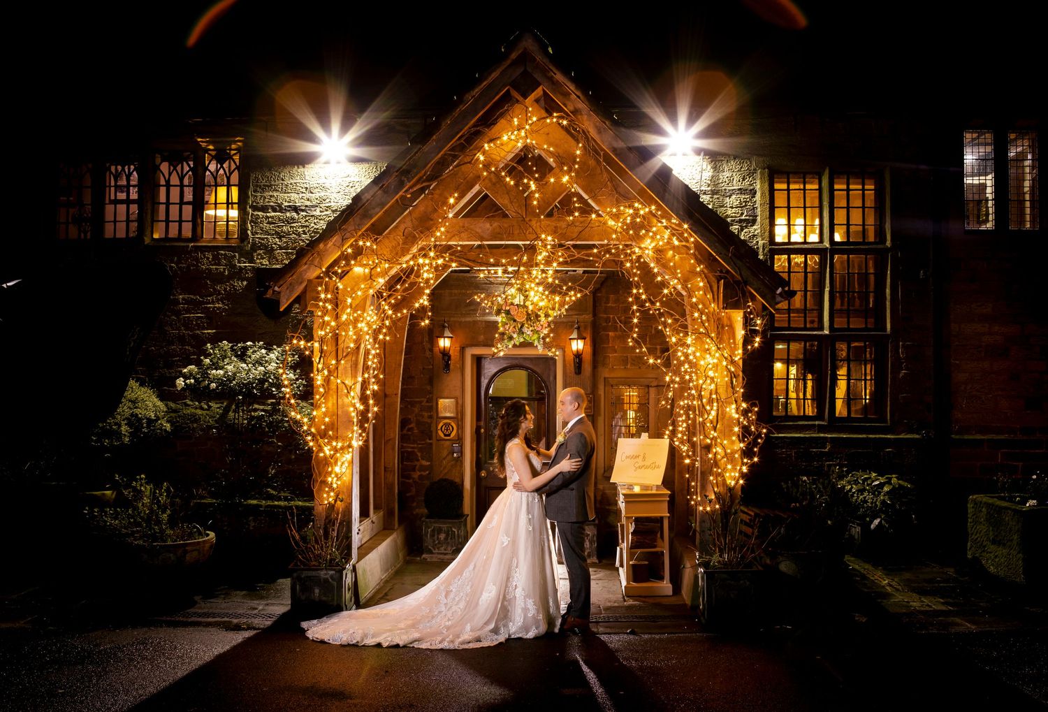 wedding photograper at whitley hall hotel entrance under lights