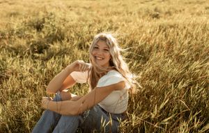 Portrait in golden wheat field during sunset with natural lighting.