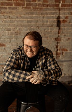 Candid portrait against rustic brick wall background.