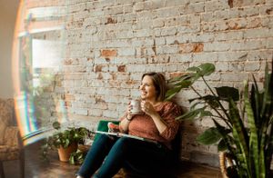 Interior lifestyle photo with natural window light and exposed brick wall.