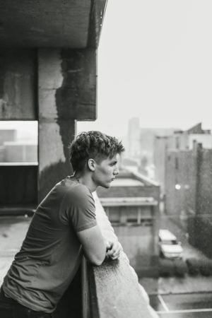 Moody black and white urban portrait overlooking city buildings.