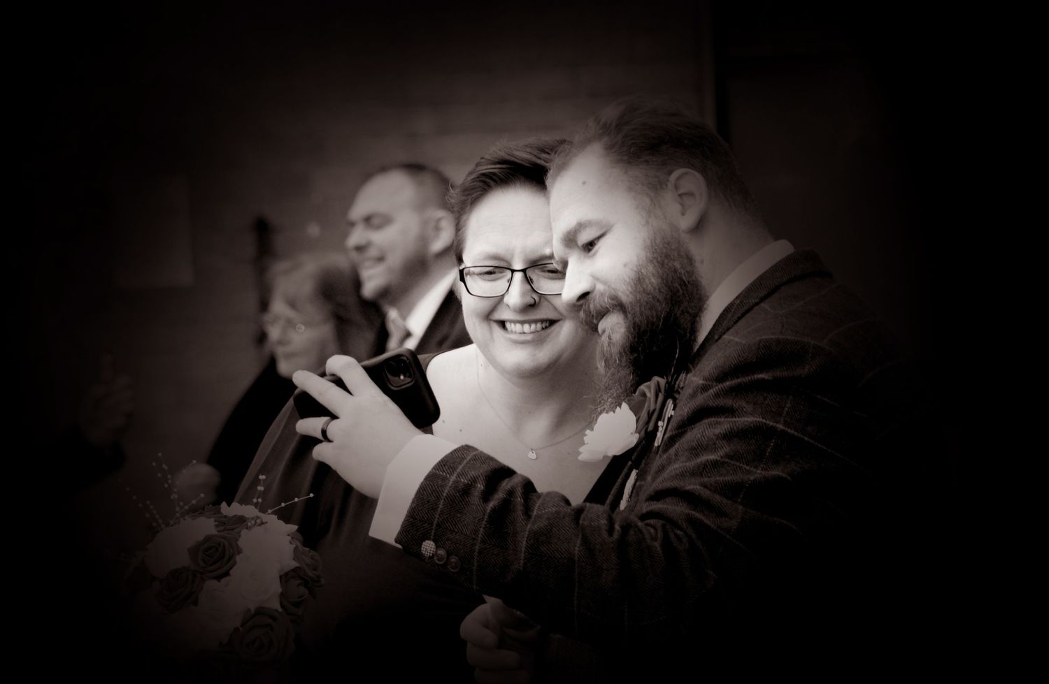 Bride and Groom sharing a funny moment on their phone at their wedding in Warwickshire