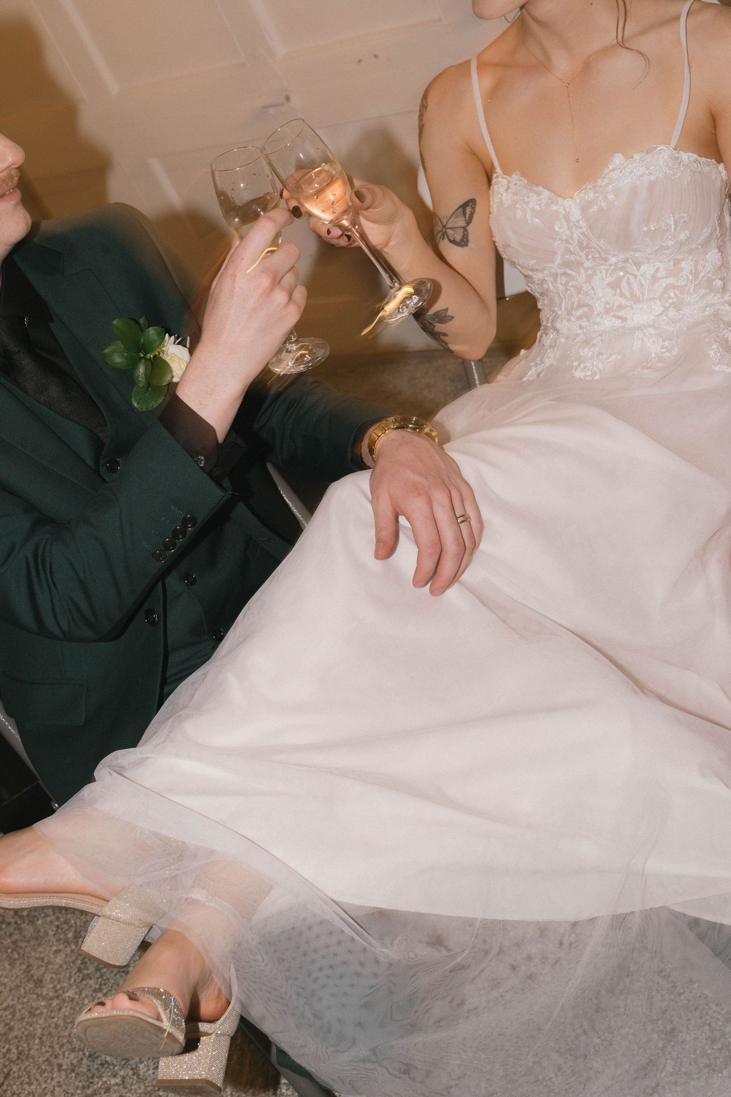 Wedding guests toasting with champagne glasses while seated.