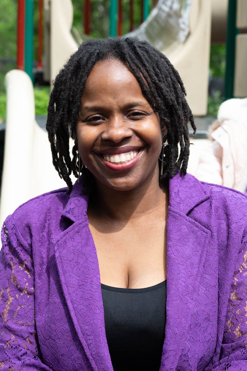 Pixs By Tina captures Shonda McCants in a professional headshot showing wearing a purple blazer and black top with a bright smile.