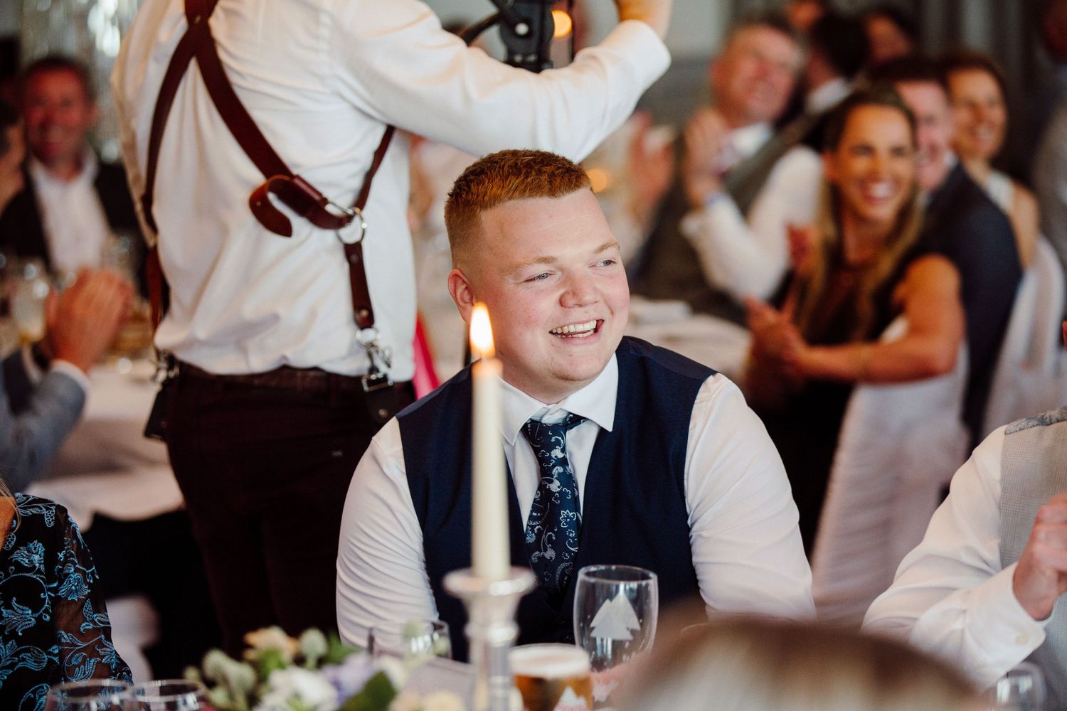 Guest enjoying a lighthearted moment during wedding reception dinner service.