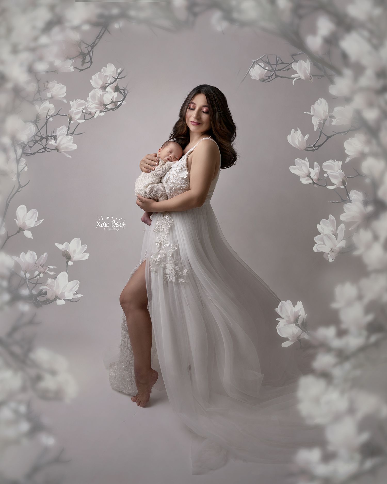 Ethereal white dress portrait surrounded by delicate white magnolia blossoms.
