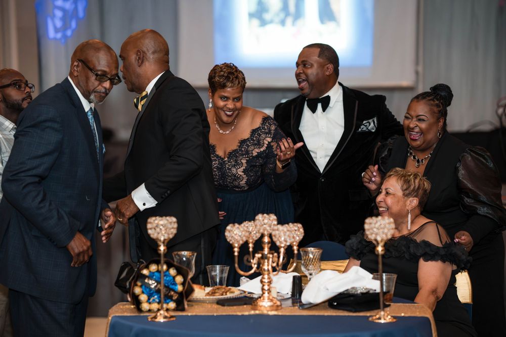 Guests gathered around a formal dining table during an elegant celebration event.