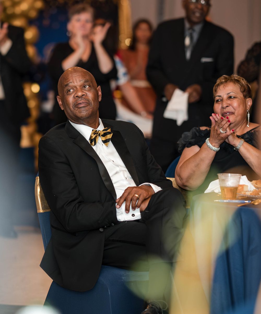 Guests enjoying and reacting emotionally during a formal event celebration.