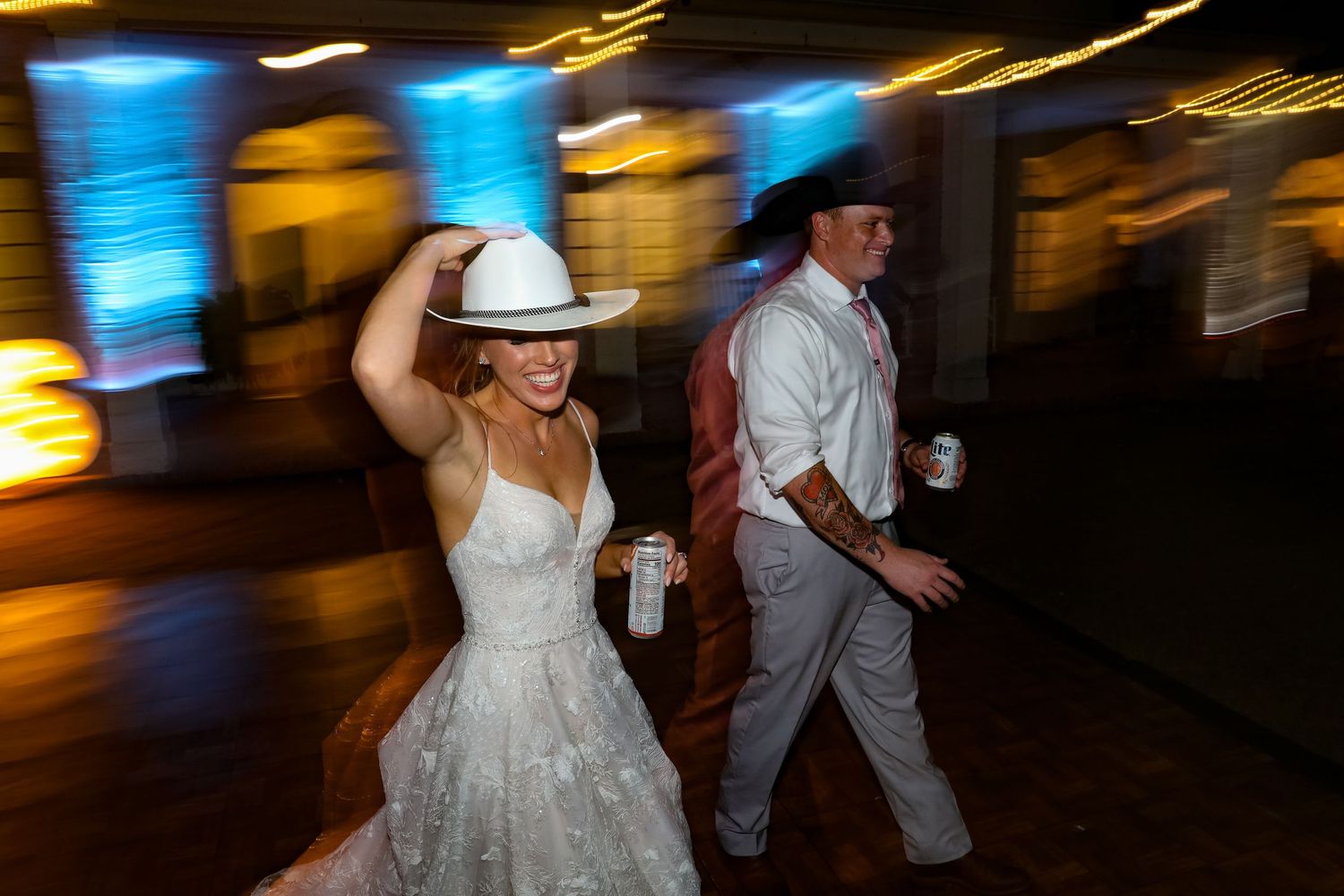 Newlyweds dancing and celebrating at their wedding reception with motion blur.