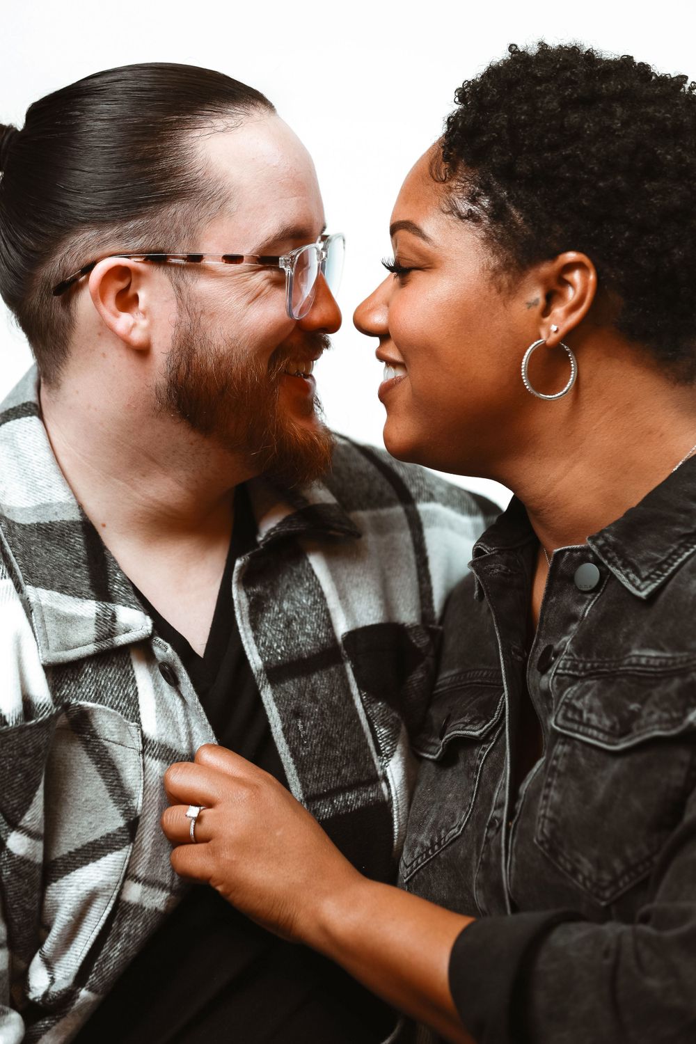 Close up portrait of loving couple sharing intimate moment in casual attire.