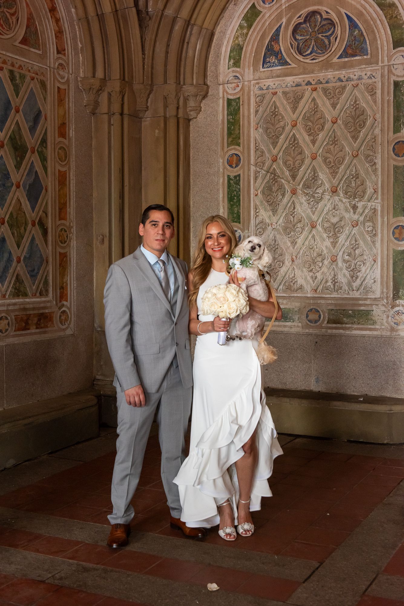 Wedding portraits taken in an ornate terrace with decorative wall patterns.