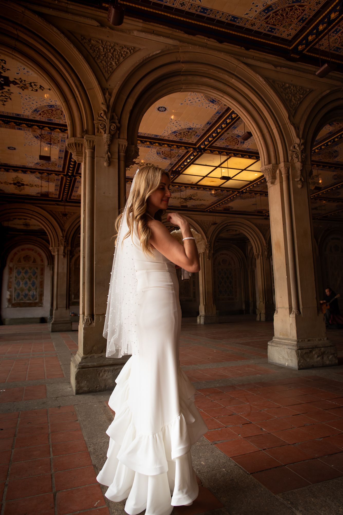 Elegant wedding ceremony venue with ornate ceiling, columns and terracotta flooring.