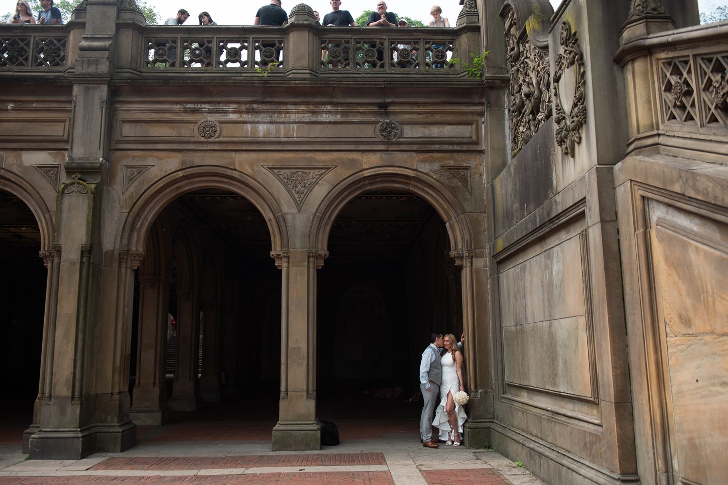 Architectural details of a historic stone colonnade with arches and columns.