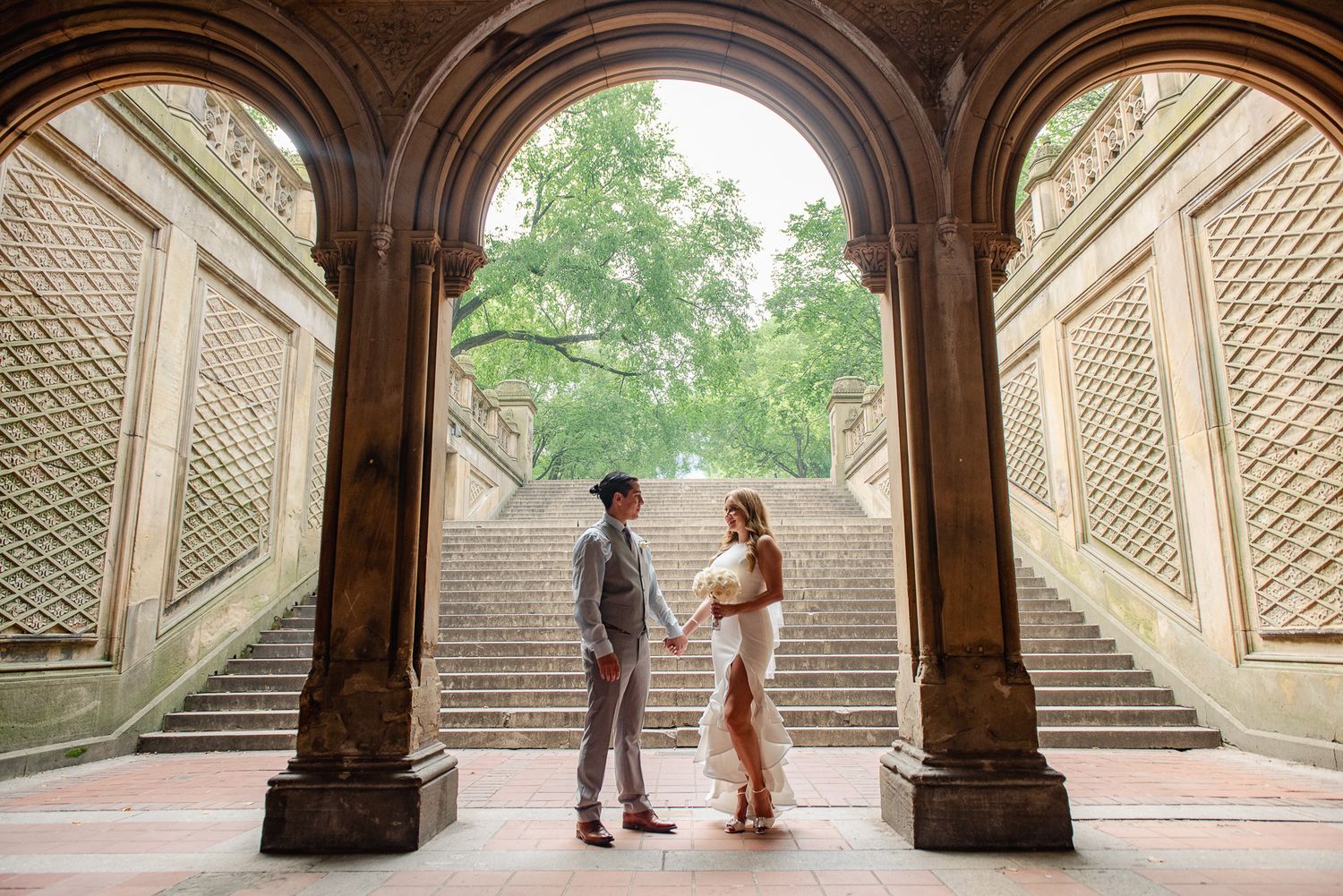 Stone archways and staircases create a romantic architectural backdrop in Central Park.
