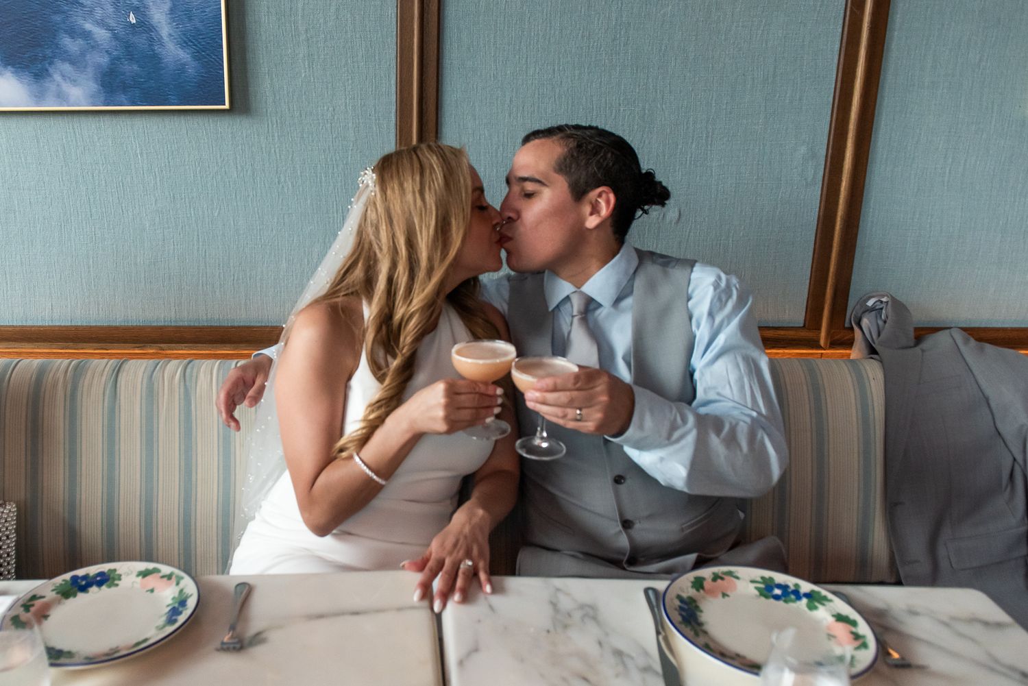 Intimate wedding reception moment at elegant restaurant table.