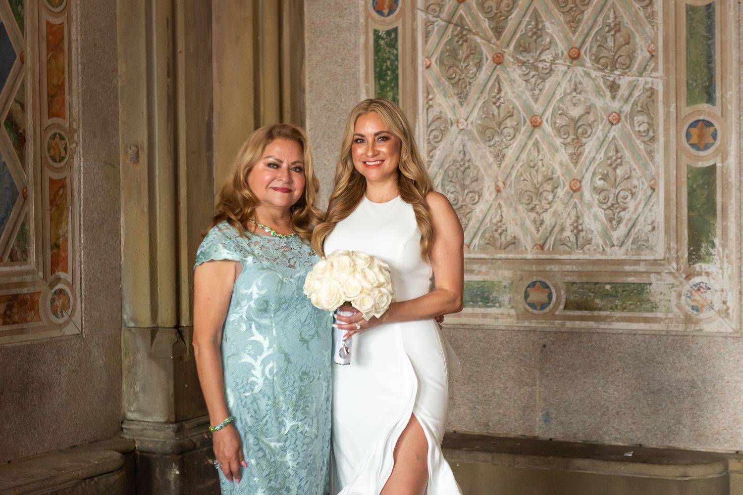 Wedding group portraits with decorative architectural elements and patterns in background.
