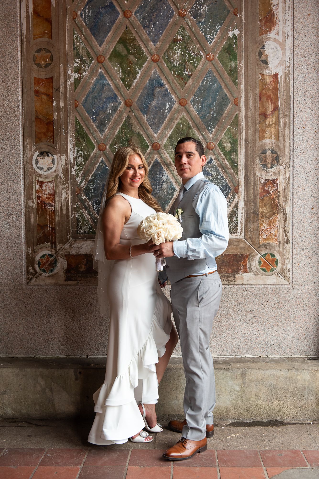 Wedding portraits captured in sequence along ornate historic corridor.