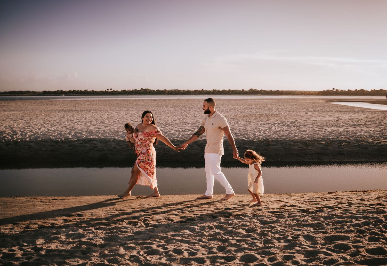 Family walking on the beach at sunset at Matanzas Inlet St Augustine Florida