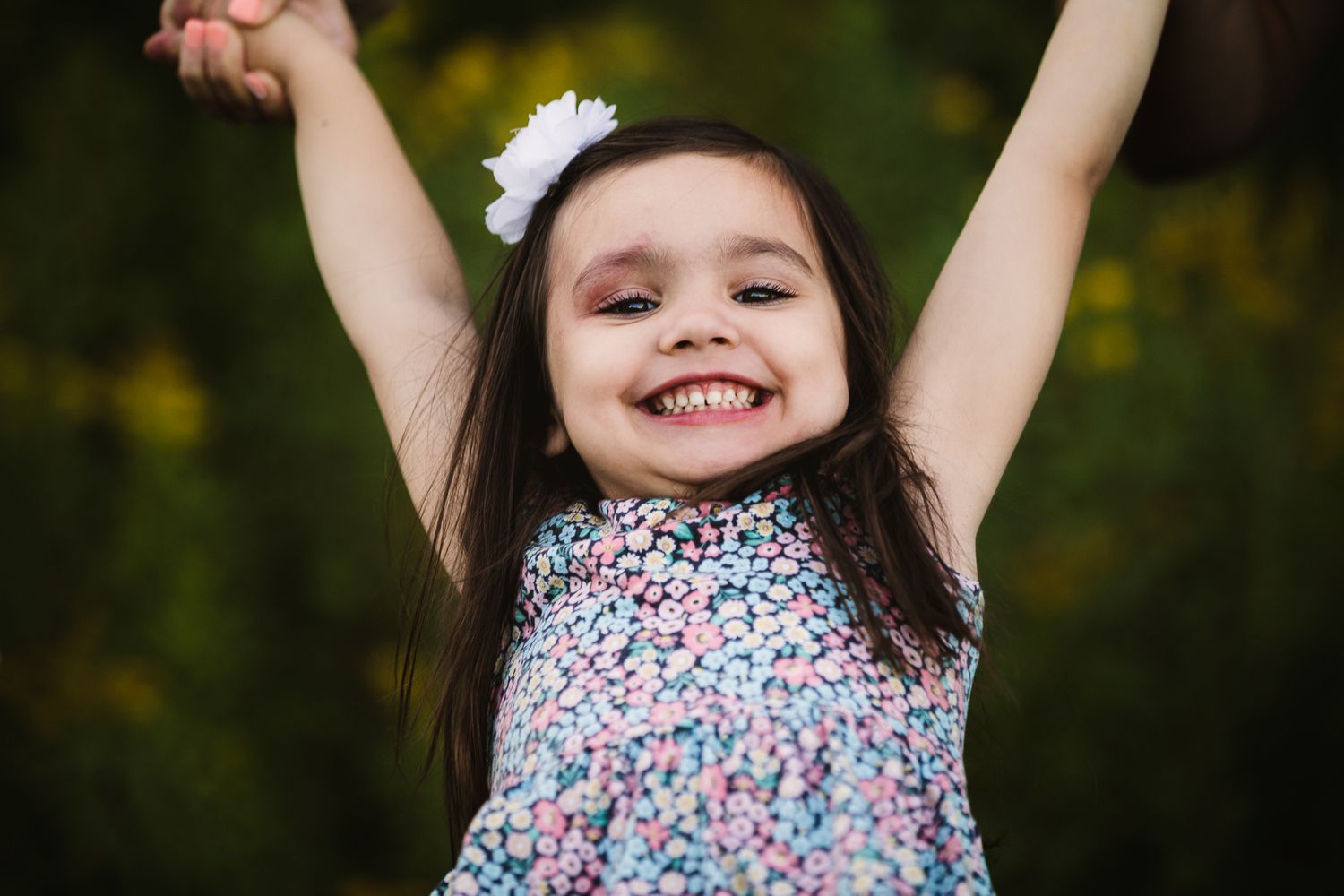 Girl laughing and playing at outdoor summer family adventure session