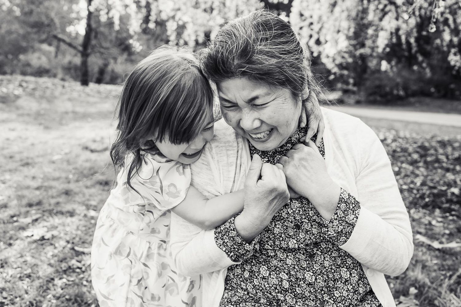 Bellevue photographer captures black and white candid image of grandma and grandchild hugging in the spring