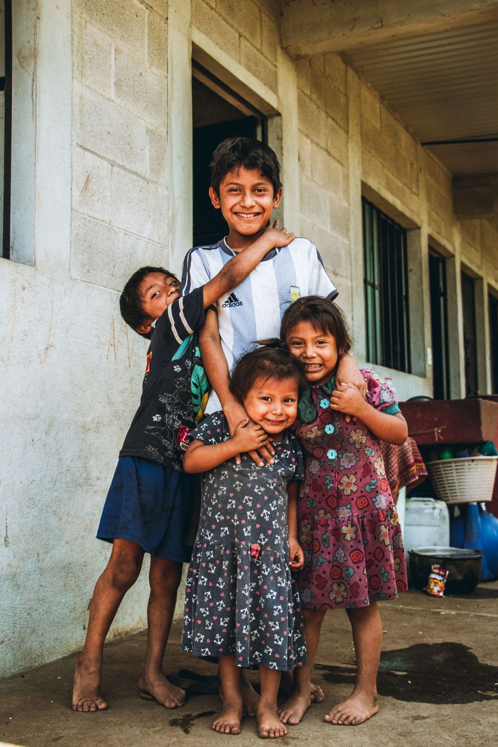 Group playing and laughing together on a porch in Guatemala.