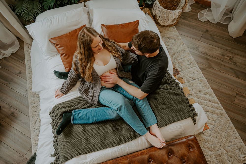 Pregnant woman is held by her husband