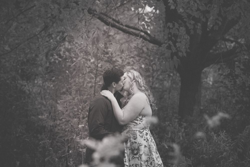 A black and white romantic photoshoot series in a natural outdoor setting.