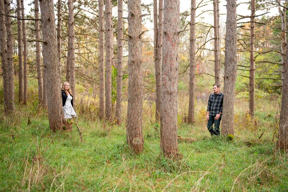 A romantic forest photoshoot with towering pine trees creating a natural backdrop.