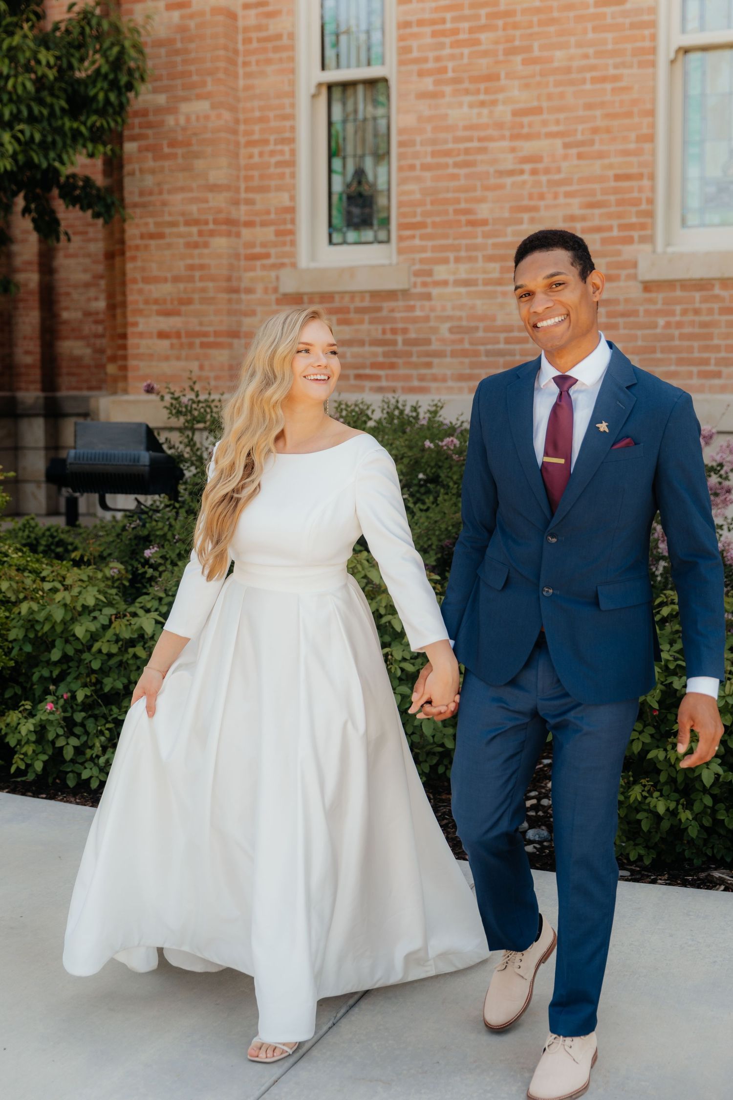 Newlywed Couple holding hands and walking at the Provo City Center LDS Temple