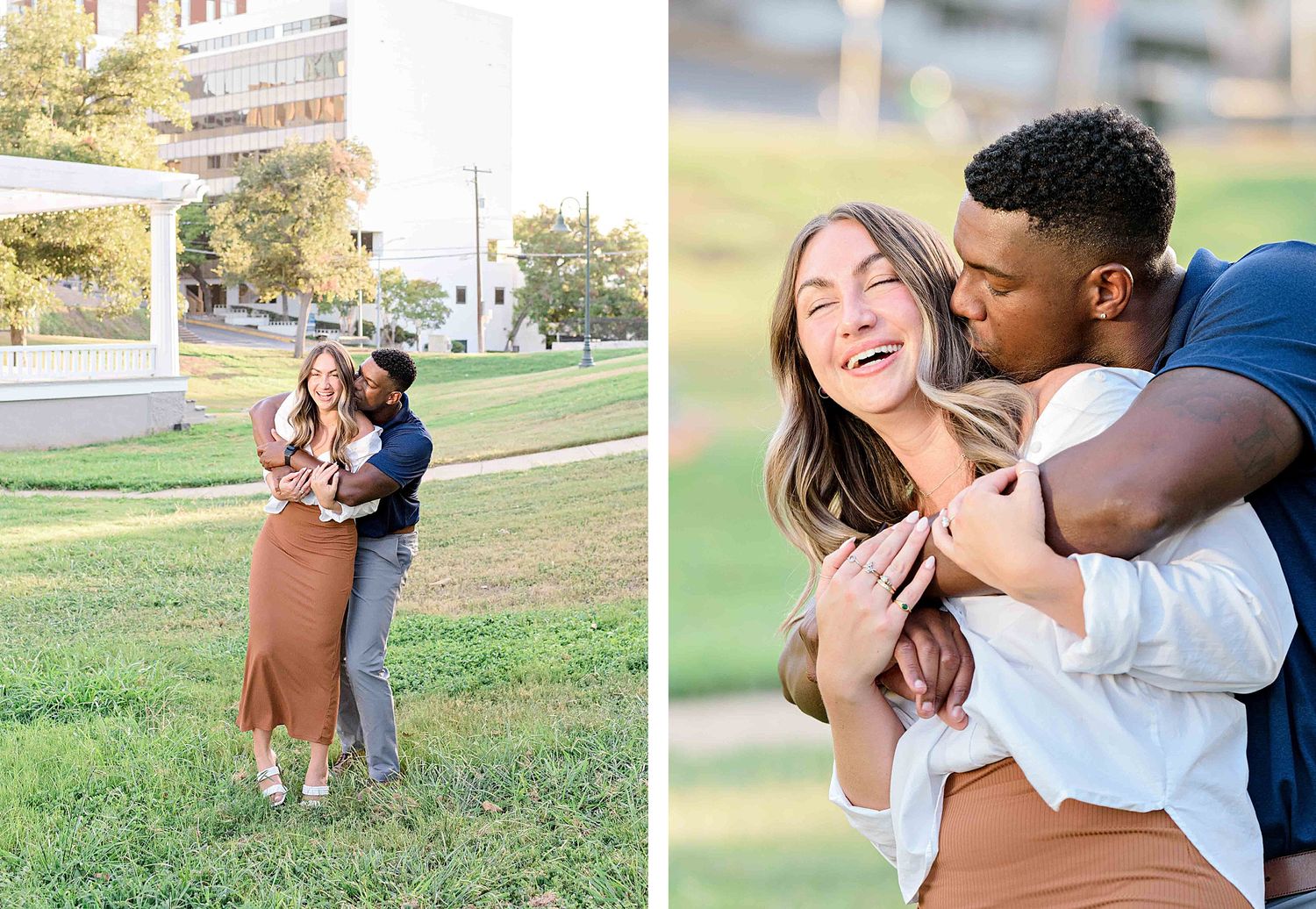 A joyful couple laughs and embraces while taking engagement photos in a grassy park.