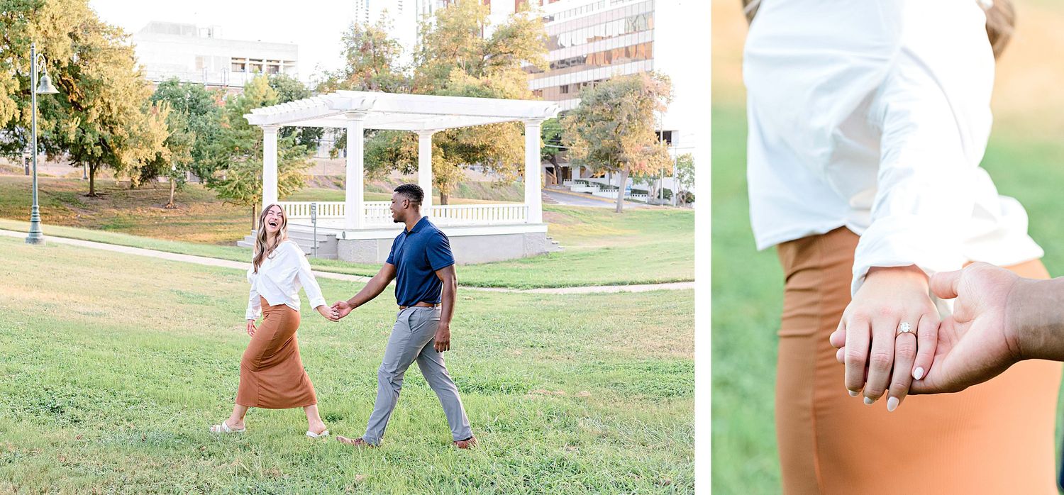 A couple walking together in a park with a white gazebo in the background on a sunny autumn day.