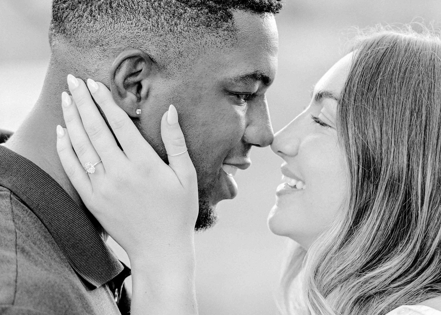 A tender black and white portrait of a couple in an emotional embrace.