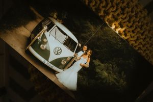 Vintage Volkswagen bus with newlyweds photographed through textured fabric.