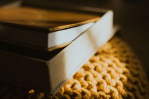 Elegant photo album displayed on textured surface with warm ambient lighting.