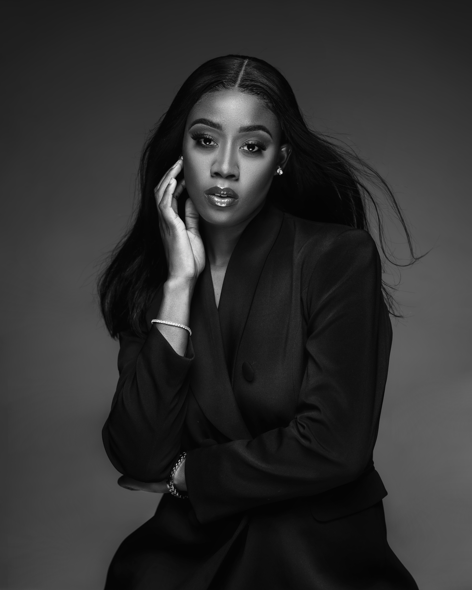 Black and white portrait showcasing elegant professional styling and dramatic lighting.