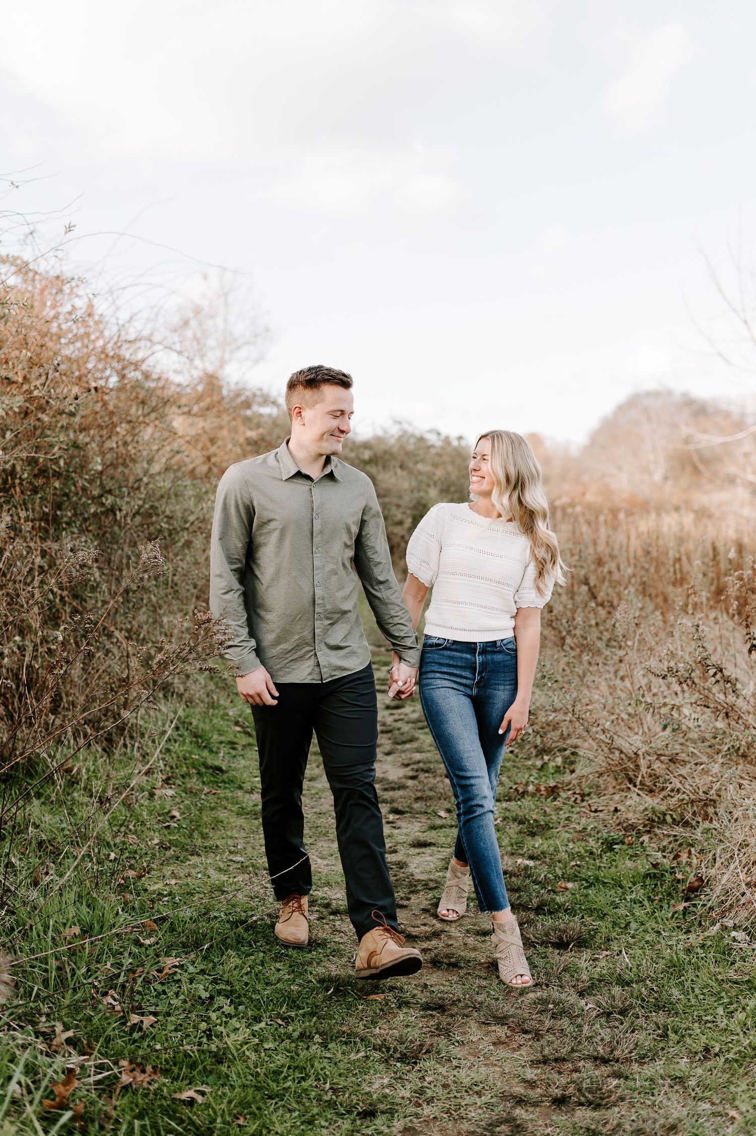 Couple sharing a sweet moment while walking along a nature path.
