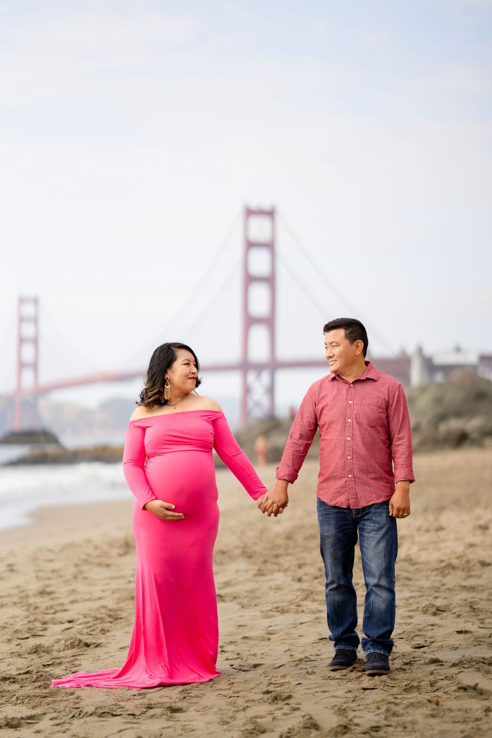 A maternity photo session at Baker Beach with the Golden Gate Bridge in the background.