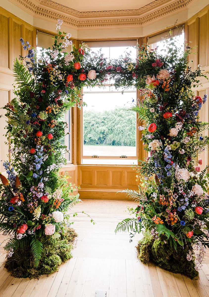 natural flower arch in wedding ceremony room by wild gorse