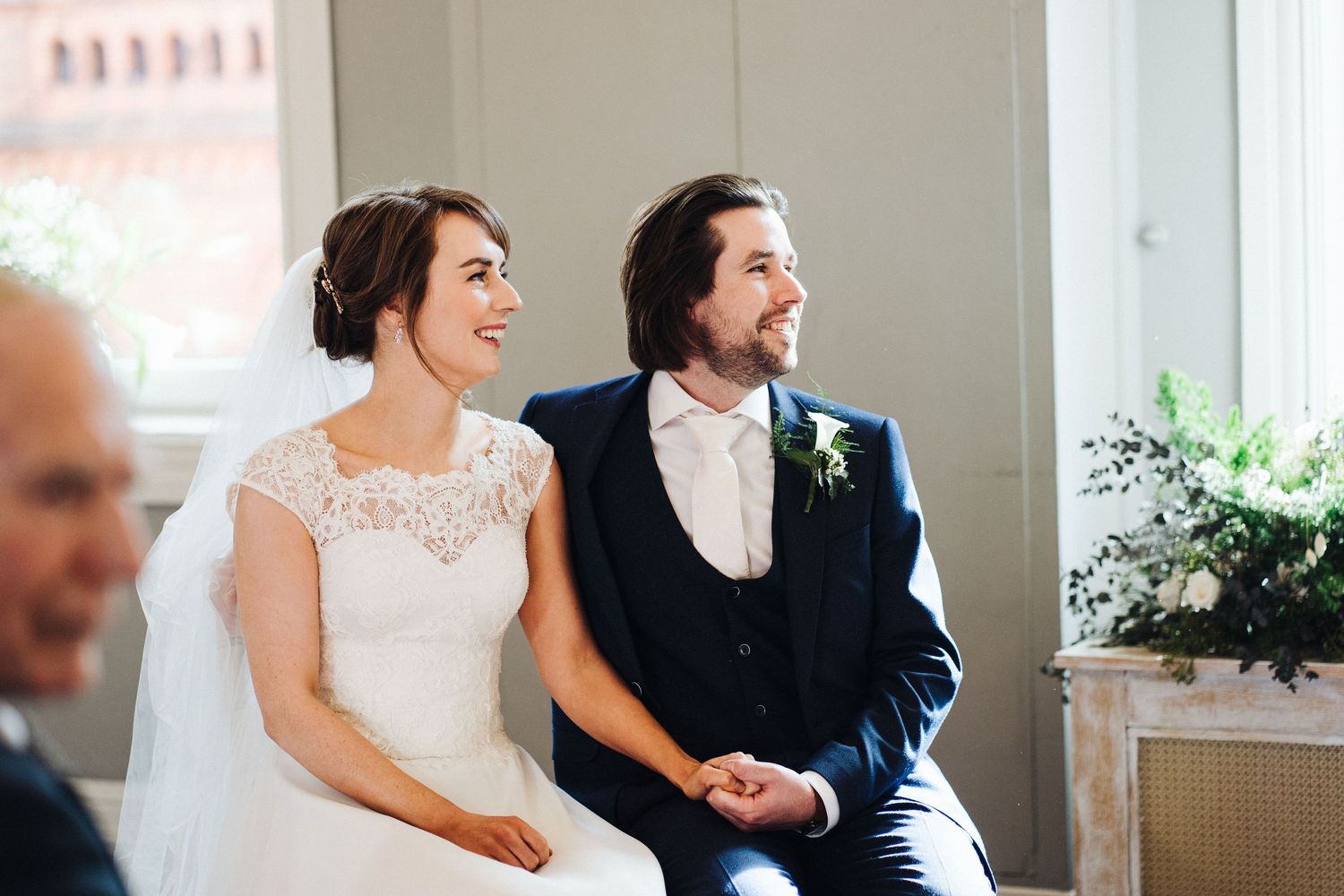 A couple shares a joyful moment during their wedding ceremony.