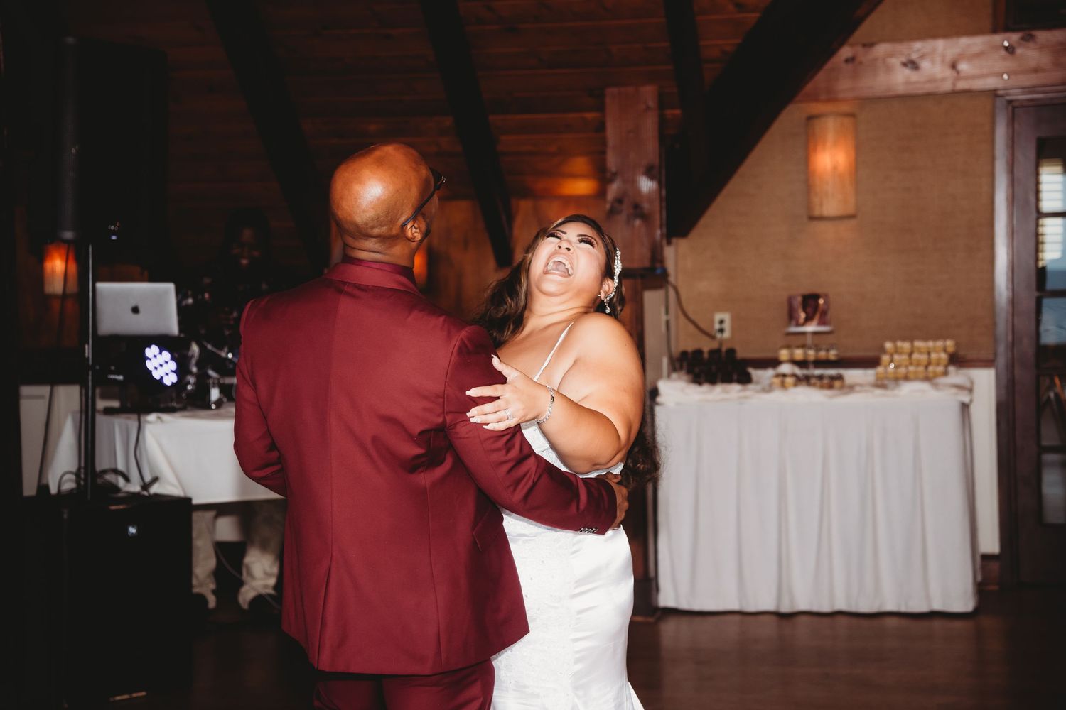 A couple shares an intimate dance together at their wedding reception.