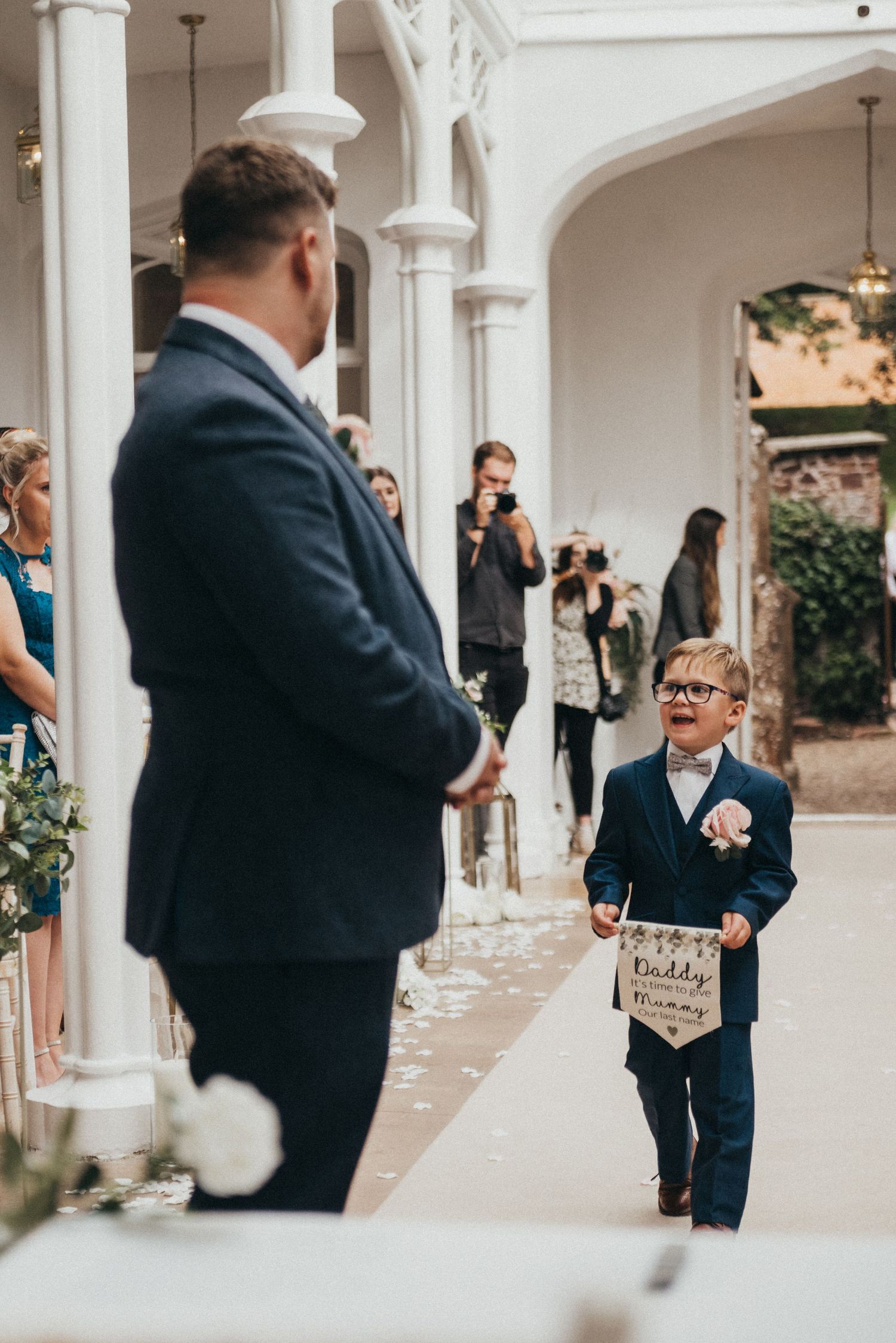 Wedding ceremony moment in an elegant white columned venue.