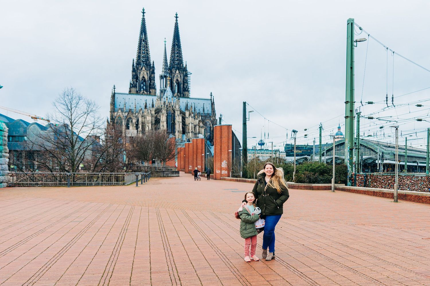 A scenic view of Cologne Cathedral and bridge with love locks on a winter day.
