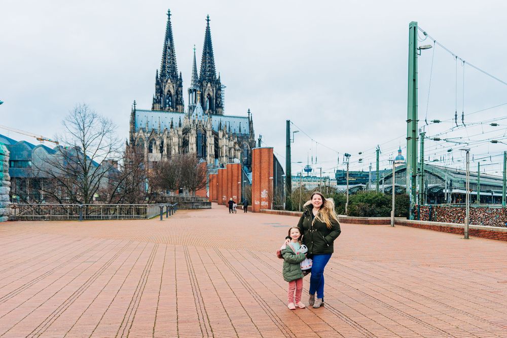 A scenic view of Cologne Cathedral and bridge with love locks on a winter day.